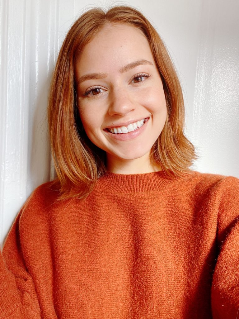 girl in orange sweater
